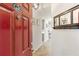 Stylish entryway with a red door, coat rack, and view into the home at 2700 Pine Tree Ne Rd # 2201, Atlanta, GA 30324