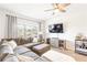 Comfortable living room with large sectional sofa, TV, and natural light at 2700 Pine Tree Ne Rd # 2201, Atlanta, GA 30324