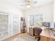 Well-lit home office featuring a large window, desk setup, and access to the balcony at 2700 Pine Tree Ne Rd # 2201, Atlanta, GA 30324