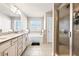 Bathroom featuring a sink with granite countertops, soaking tub, and a tile shower at 332 Hinton Farm Way, Dacula, GA 30019