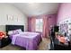 Charming bedroom featuring purple walls, black furniture, and a window with soft lighting at 332 Hinton Farm Way, Dacula, GA 30019