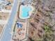 Aerial view of a community pool and a playground, providing recreational options for residents at 332 Hinton Farm Way, Dacula, GA 30019