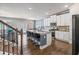 Spacious kitchen island featuring granite countertops, modern appliances, and an adjoining breakfast bar at 332 Hinton Farm Way, Dacula, GA 30019