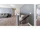 Upstairs landing showcasing a comfortable seating area with plush carpeting and neutral-colored walls at 332 Hinton Farm Way, Dacula, GA 30019