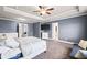 Bright main bedroom with a tray ceiling, TV, and stylish gray color scheme at 332 Hinton Farm Way, Dacula, GA 30019