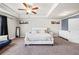 Spacious main bedroom featuring a tray ceiling, ceiling fan, and ample natural light at 332 Hinton Farm Way, Dacula, GA 30019