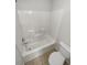 Clean bathroom with white tiled shower and floor, and a standard toilet at 4190 Haynes Mill Nw Ct, Kennesaw, GA 30144