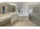 Bright bathroom featuring a garden tub, glass shower, and vanity with ample counter space at 4190 Haynes Mill Nw Ct, Kennesaw, GA 30144