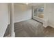 A spacious carpeted room with natural light from the window and stylish pillars at 4190 Haynes Mill Nw Ct, Kennesaw, GA 30144