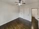 Bright bedroom with a ceiling fan, closet doors, and rich, dark hardwood floors at 4190 Haynes Mill Nw Ct, Kennesaw, GA 30144