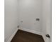 A practical laundry room features clean white walls and dark hardwood flooring at 4190 Haynes Mill Nw Ct, Kennesaw, GA 30144