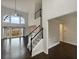 View of staircase and living room with cathedral ceiling and many windows at 4190 Haynes Mill Nw Ct, Kennesaw, GA 30144