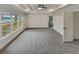 Bright main bedroom featuring a tray ceiling, large window and neutral carpeting at 4190 Haynes Mill Nw Ct, Kennesaw, GA 30144