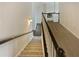 Carpeted staircase with stained wood railing and white risers in a brightly lit home at 4190 Haynes Mill Nw Ct, Kennesaw, GA 30144