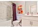 Bright bathroom with a tub/shower combination, decorative painting, and a clean white vanity at 429 Stagecoach Bnd, Smyrna, GA 30080