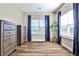 Bright bedroom with large windows, hardwood floors, and dark wood dressers at 429 Stagecoach Bnd, Smyrna, GA 30080