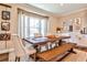 Charming dining room with rustic wooden table, bench seating, and natural light from a large window at 429 Stagecoach Bnd, Smyrna, GA 30080