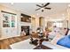 Open-concept living room features a fireplace, ceiling fan, hardwood floors, and access to the kitchen and dining area at 429 Stagecoach Bnd, Smyrna, GA 30080