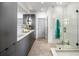 Modern bathroom featuring sleek gray cabinetry, dual sinks, and a glass-enclosed shower at 726 Edgewood Ne Ave, Atlanta, GA 30307