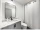 Modern bathroom with granite countertop vanity, sleek fixtures, and a separate shower area at 726 Edgewood Ne Ave, Atlanta, GA 30307