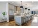 Modern kitchen with stainless steel appliances, quartz countertops, large island and pendant lighting at 726 Edgewood Ne Ave, Atlanta, GA 30307