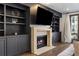 Cozy living room with built-in shelving, fireplace and large screen television at 726 Edgewood Ne Ave, Atlanta, GA 30307