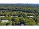 Aerial view of a community with lush greenery and tree coverage, with a view of the Atlanta skyline in the distance at 80 Adrian Pl, Atlanta, GA 30327