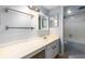 Traditional bathroom with white vanity, tub, and shower combination with blue and white tile at 80 Adrian Pl, Atlanta, GA 30327