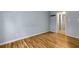 Clean bedroom with wood-look floors and a doorway leading to an adjoining bathroom at 80 Adrian Pl, Atlanta, GA 30327