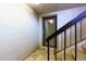 Hallway with stairs leading to unit 804, featuring black metal railings and tile floors at 80 Adrian Pl, Atlanta, GA 30327