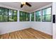 Cozy sunroom featuring wood-look flooring, lots of natural light, and a peaceful view at 80 Adrian Pl, Atlanta, GA 30327