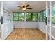 Bright and airy sunroom with a ceiling fan, wood-look flooring, and wall-to-wall windows at 80 Adrian Pl, Atlanta, GA 30327