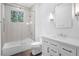 Modern bathroom featuring a shower-tub, sleek vanity, and neutral finishes at 819 Loridans Ne Dr, Atlanta, GA 30342