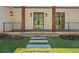 Inviting covered porch with wooden columns, stone walkway, and stylish sconces at 819 Loridans Ne Dr, Atlanta, GA 30342