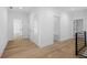 Upstairs hallway with wood floors, white walls, and multiple entryways at 819 Loridans Ne Dr, Atlanta, GA 30342