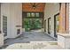 Covered patio includes a gas fireplace with stone pavers and wood ceiling with ceiling fan at 819 Loridans Ne Dr, Atlanta, GA 30342