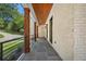 Beautiful porch with a stone floor, wooden ceiling and pillars, and modern railings at 819 Loridans Ne Dr, Atlanta, GA 30342