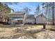 This is a backyard view with a patio, seating, a built-in fire pit, and a detached garage at 36 Pooles Bend Ct, Hiram, GA 30141