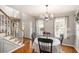 Bright dining room featuring hardwood floors, chandelier lighting, and a staircase for upstairs access at 36 Pooles Bend Ct, Hiram, GA 30141