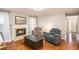 Living room with fireplace, hardwood floors, natural light, and comfortable seating at 36 Pooles Bend Ct, Hiram, GA 30141