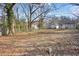 The backyard has a large area of leaves, and a chain link fence at 556 Holly Nw St, Atlanta, GA 30318