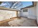 Back of home features a storage shed, white painted brick, and a concrete patio at 556 Holly Nw St, Atlanta, GA 30318