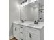 Bright bathroom boasts a double sink vanity with white cabinets and black hardware at 556 Holly Nw St, Atlanta, GA 30318