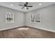 Spacious bedroom features wood-look floors, neutral paint, and two windows at 556 Holly Nw St, Atlanta, GA 30318