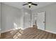 Bedroom features wood floors, a ceiling fan, and a doorway to another room at 556 Holly Nw St, Atlanta, GA 30318