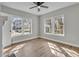 Bedroom with a ceiling fan, laminate flooring, and large windows for natural light at 556 Holly Nw St, Atlanta, GA 30318