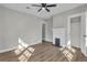 Bedroom with a ceiling fan, decorative fireplace, laminate flooring, and closet at 556 Holly Nw St, Atlanta, GA 30318