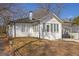 Charming bungalow showcasing a painted brick facade, carport, and tidy front yard at 556 Holly Nw St, Atlanta, GA 30318