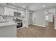 Modern kitchen features stainless steel appliances, white cabinets, and laminate flooring at 556 Holly Nw St, Atlanta, GA 30318