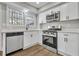 Bright kitchen featuring white cabinetry, quartz countertops, and stainless steel appliances at 556 Holly Nw St, Atlanta, GA 30318